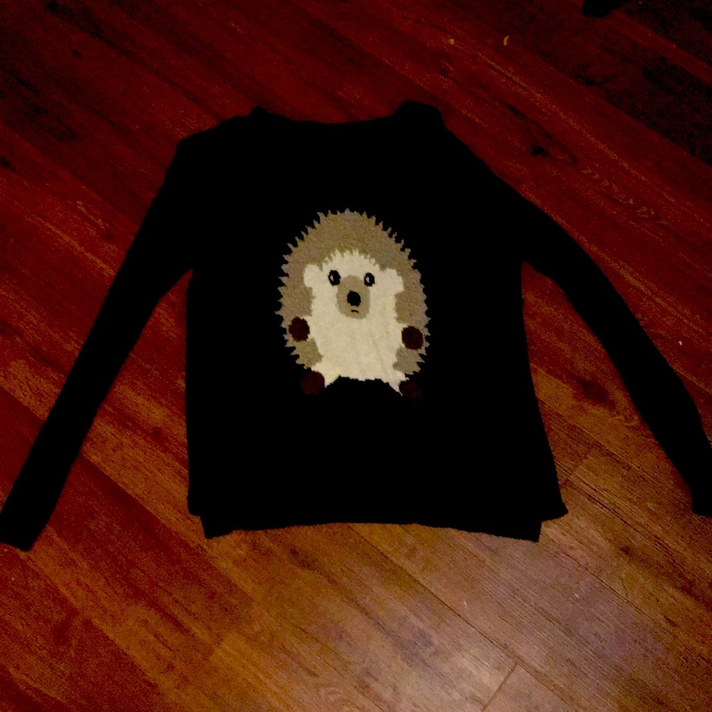 Black sweater with an animal on it
